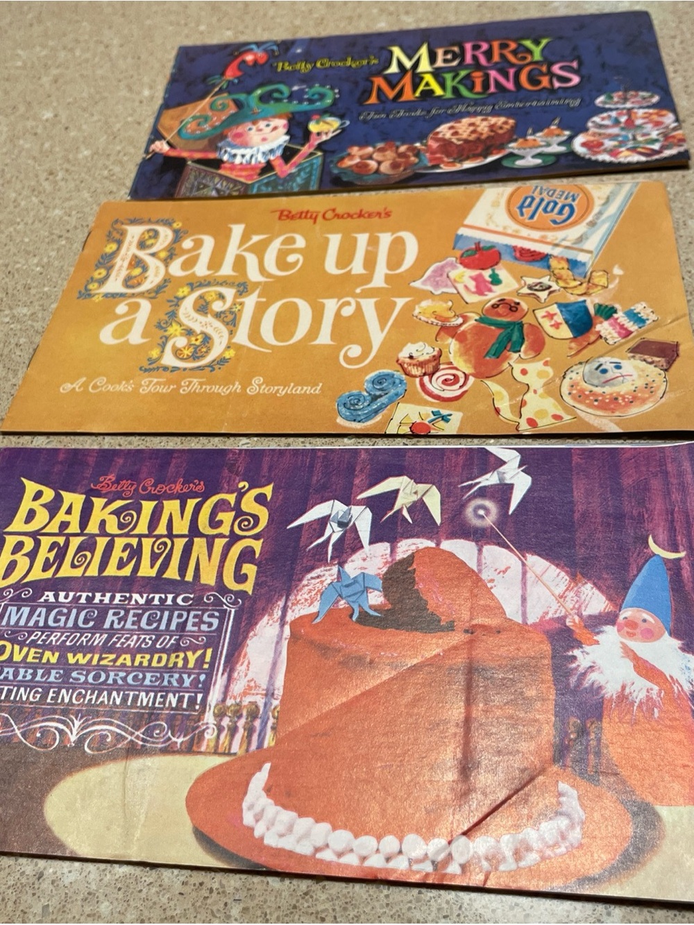 Betty Crocker cookbook set with purple, orange, and yellow covers